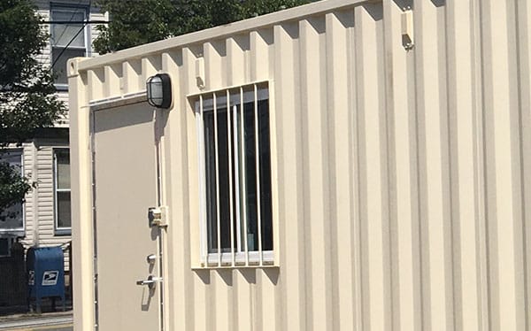 Modified shipping container with window & security bars