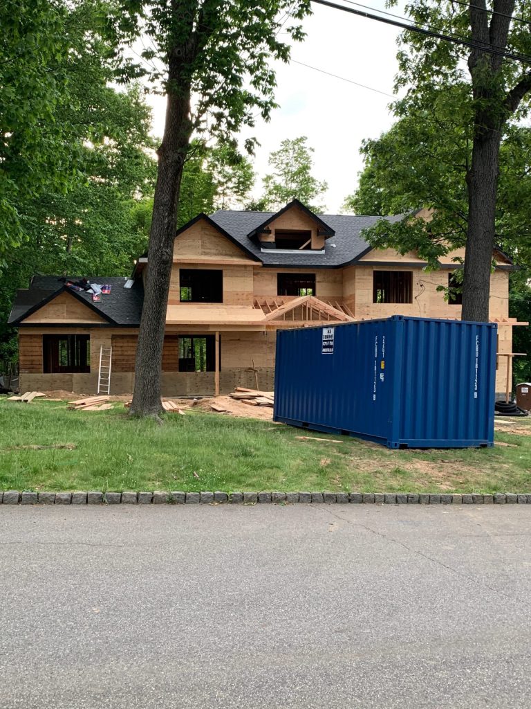 Image of a storage container from Jake Containers in front of a house
