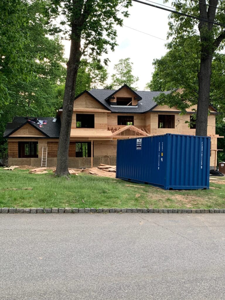 Image of a portable storage container in front of a home